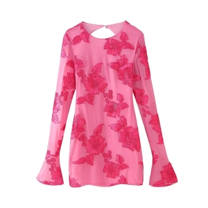 Detail of pink mini dress featuring 3D floral embroidery and back teardrop cutout detail