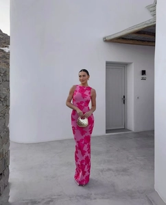 Detail of rose pink sleeveless maxi dress with large floral prints and golden handbag