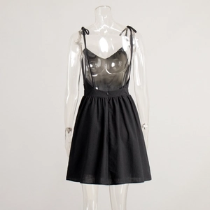 Detail of black mini dress featuring adjustable tie shoulder straps and invisible back zipper