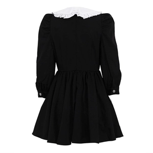 Detail view of the back of a French black and white pleated dress with ruffled collar