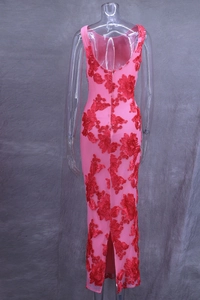 Detail of pink embroidered maxi dress featuring 3D floral appliqués and back slit
