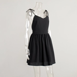 Close-up of black cotton backless mini dress with spaghetti straps and high waist detail