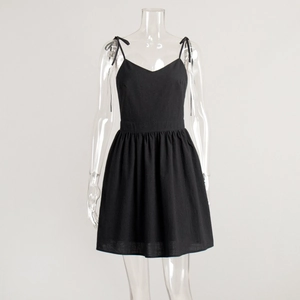 Detail of black cotton A-line dress with V-neck and adjustable tie shoulder straps