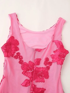 Close-up of pink mesh dress featuring 3D floral appliques and a hidden back zipper
