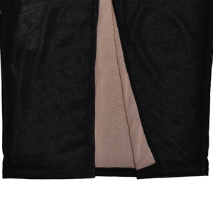 Detail view of black mesh dress showing slit hem with beige lining and fine stitching