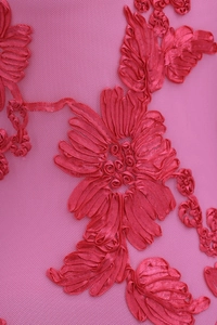 Close-up of 3D rose pink floral embroidery on delicate mesh fabric for dresses