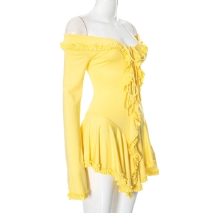 Detail of yellow off-shoulder dress with ruffled edges and lace-up front design