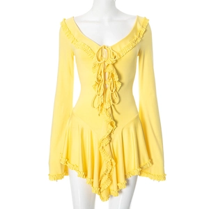 Detail of yellow long sleeve dress with V-neck ruffles and lace-up front strings