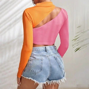 Detail view of pink and orange rib-knit crop top with asymmetrical back cutout design