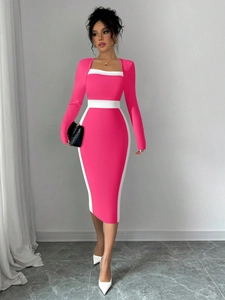 Detail of the elegant fuchsia knit dress showing the square neckline and waist stripes