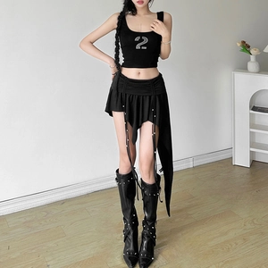 Close-up of black irregular skirt featuring long fringe drawstrings and asymmetrical hem