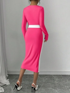 Detail view of pink and white color block midi dress showing body-con fit and back waistline