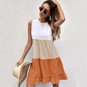 Detail of color-block sleeveless dress featuring ruffled hem and summer texture