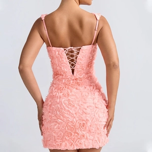 Detailed back view of pink mini dress with 3D floral textures and lace-up straps