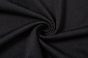 Close-up of premium black knitted fabric showing dense texture and soft elastic drape