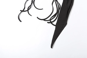 Detailed close-up of the adjustable black drawstring ties and irregular hemline fabric