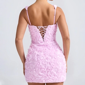 Detail of the back cross-tie design and 3D rose floral texture on pink mini dress