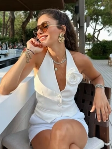 Elegant white halter neck vest with 3D floral accent and matching shorts set for women
