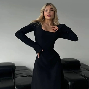 Detail of elegant square neckline on slim fit black long sleeve dress with premium knit fabric