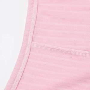 Close-up of light pink breathable mesh knit fabric with neat stitching and reinforced seams