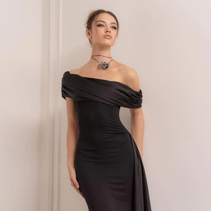 Detail of elegant off-shoulder draped neckline on a slim fit black maxi dress