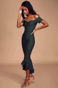 Detail shot of the elegant mermaid hem and off-shoulder neckline on dark green dress
