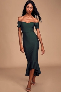 Close-up of mermaid hem and ruffled detail on elegant dark green off-shoulder dress
