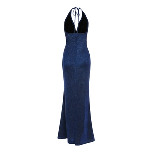 Detail of navy blue sequined fabric on backless halter gown with fishtail hemline
