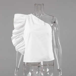 Detailed macro view of the pleated ruffle accent on the white one-shoulder cotton top