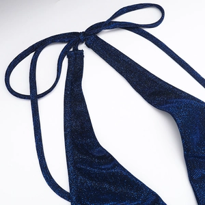 Detailed macro view of the sparkly blue halter neckline fabric with lurex shimmer texture