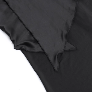 Detailed close-up of smooth black satin fabric with fine stitching and pointed hem design