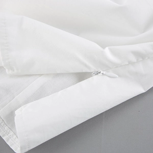 Detail of white cotton top featuring a high-quality invisible zipper and fine stitching