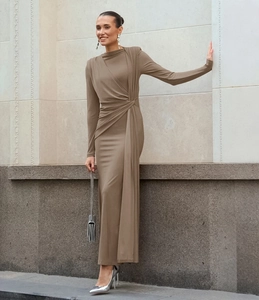 Detail of elegant round neck long dress with side twist knot and draped waistline design