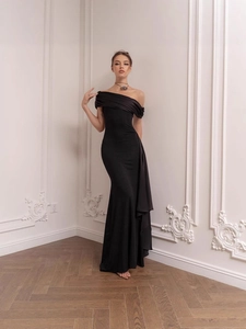 Elegant black off-the-shoulder evening gown with draped ribbon and slim fit silhouette