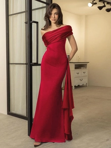 Elegant deep red one-shoulder evening dress with pleated satin fabric and draped sash