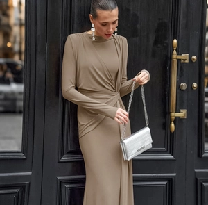Detail of twisted waist design on long-sleeve taupe slim-fit maxi dress