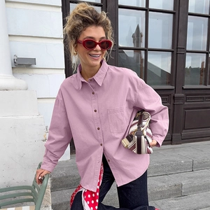 Detail of lavender oversized cotton shirt featuring breast pocket and amber buttons
