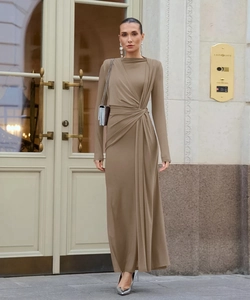 Detailed view of the elegant cross-knot waist draping on this long brown evening dress