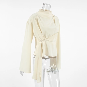 Detail of French chiffon blouse featuring stand collar and waist-tie closure in apricot