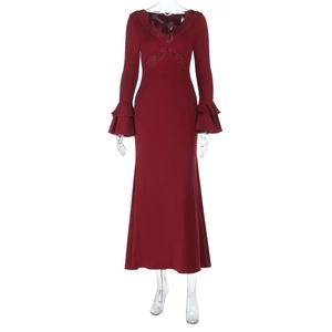Macro detail of V-neck lace trim and layered ruffle cuffs on a red maxi dress