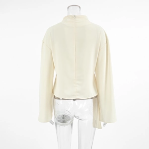 Detail of apricot chiffon blouse back with a stand collar and invisible zipper closure