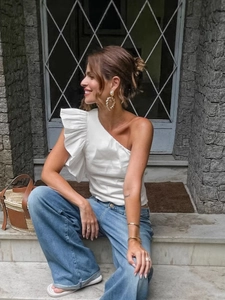 French vintage white off-shoulder cotton top with ruffles and blue wide-leg jeans