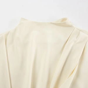 Detail of elegant pleated high collar on a cream-colored French style chiffon blouse