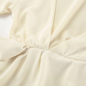 Close-up of the elegant V-neckline and gathered waist detail on this ivory chiffon blouse