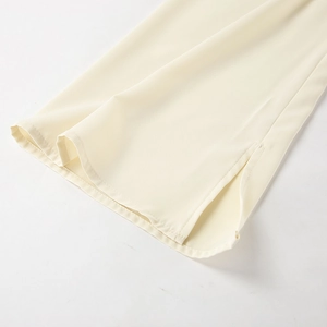 Detail of flared cuff on cream chiffon blouse with high-quality stitching and side slit