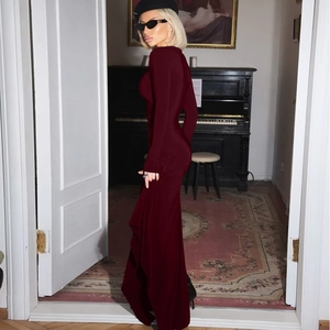 Detail view of burgundy slim-fit long sleeve maxi dress with elegant ruched waist design
