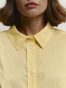 Relaxed fit pale yellow cotton shirt for women featuring a classic collar and white buttons