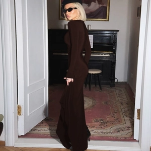Detail of slim fit dark brown long sleeve dress with waist tie and elegant floor length cut