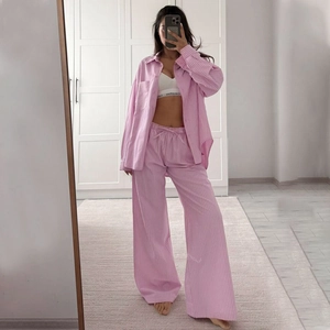 Mirror selfie showing a pink and white striped long sleeve pajama set with wide-leg pants