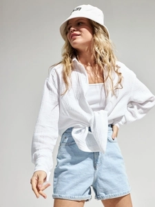 Detail of white cotton crepe shirt with buttoned collar and stylish knotted hem